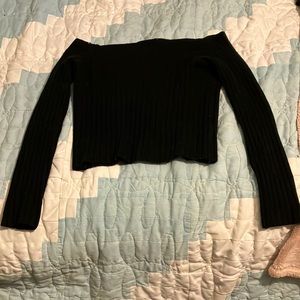 This is a black long sleeve crop top. In size medium.